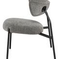 Side view showing chair’s angled black metal frame and curved seat and backrest
