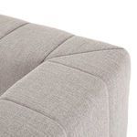 Close-up of sectional’s seat and back corner showing rounded cushioned edges and vertical channels