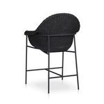 Slightly angled rear corner view showing woven frame shape wrapping around metal support