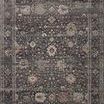 Traditional style area rug with muted grey, beige, and blue floral motifs and a decorative border