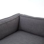Detailed close-up of dark gray fabric upholstery showing subtle crosshatch pattern