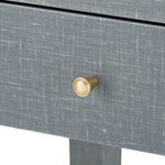 Close-up of brass drawer pull knob on washed lacquered linen drawer front