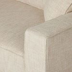 Close-up of lightly textured beige fabric on Peyton Sofa arm and adjacent cushion