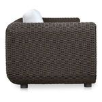 Side view highlighting rounded curved arm and wicker weave texture