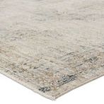 Close-up on rug corner showing low pile texture and detailed medallion edges with subtle blue and tan accents