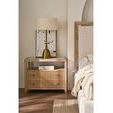 Close-up of wood nightstand with ribbed drawers, brass lamp, and decorative books near Kendall Bed