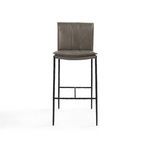 Close-up of hammered textured iron footrest bar connecting the stool legs