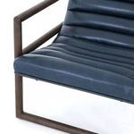 Side close-up showing detailed upholstery texture and armrest connection
