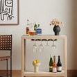 Wall gallery setting with painting hung amid other framed art pieces and bench