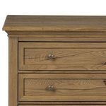 Close-up of bronzed iron round drawer knob and visible wood grain