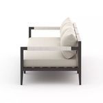 Side view of Sherwood sofa highlighting rope-wrapped armrests and rear cotton weaving texture
