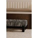 Priya bench styled at foot of wood bed frame with upholstered headboard in bedroom setting