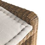Wide angle showing bench frame and cushion with rattan detailing from side
