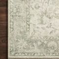 Close-up corner detail of Rosette Ivory / Silver Rug showing intricate floral pattern on dark floor