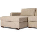 Close-up of sectional's straight track arm and adjacent seat cushion