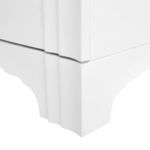 Lower corner close-up displaying scalloped base and stacked wood band details on white side table