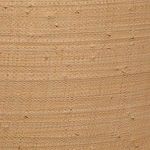 Close-up of natural raffia texture showing woven fibers and small imperfections in light tan shade