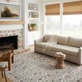 Sorrento Mist Charcoal rug styled in living room with beige sofa, wood accent table, and fireplace