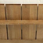 Close-up of natural teak wood slats forming the sofa back, highlighting wood texture