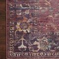 Detailed close-up of rug corner on wooden floor revealing intricate border and fringe