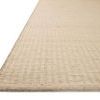 Close-up side angle showing low pile texture and whip-stitched edge of Elma Bone Rug