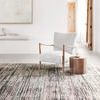 Low-angle view of Theia Grey / Multi Rug in room setting with natural light emphasizing texture and color depth