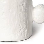 Close-up of bottom edge and texture of matte white metal surface with one spherical protrusion