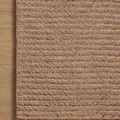 Close-up of rug’s edge on wooden floor showing ribbed texture and thickness