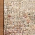 Rug corner laying on wood floor highlighting edge binding and nuanced color transitions