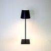 Vera Black Poldina Pro Table Lamp with sleek black metal finish, conical shade, and square base lighting a neutral space