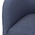 Detail close-up on blue denim fabric upholstery and curved seat cushion of Jacobsen Denim Barrel Chair