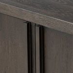 Close-up of vertical wood handles and door panel texture on the dark oak Dalton Media Console