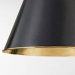 Close-up view of the brass interior rim and aged bronze exterior of the conical pendant shade