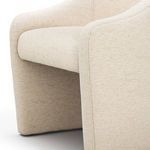 Close-up of Levi Boucle Dining Chair seat and arm upholstery featuring tight weave boucle texture