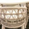 Dana Rope Dining Chair backs with woven rope pattern under white dining table in indoor setting