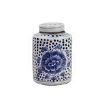 Small blue and white ceramic tea jar with hand-painted peony flower and dot pattern with lid