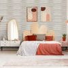 Bedroom interior showcasing wallpaper with fine horizontal gray stripes on beige, styled with bed and decor