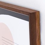 Close-up of walnut wood frame corner with gray background and sharp print edges