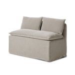 Three-quarter angle showing armless bench’s deep seat and loose back cushions