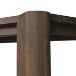 Detail view of round cornered, cylindrical table leg from a low angle