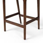 Close-up of bottom frame connecting legs with horizontal footrest bars