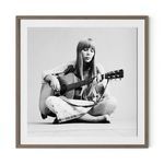 Black and white portrait of Joni Mitchell playing acoustic guitar, seated cross-legged in 1.5 inch rustic walnut frame