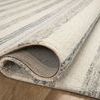 Rolled corner of Chris Ivory Slate Rug showing looped wool texture and underside backing