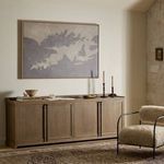 Styled room setting with Adela Sideboard beneath framed leaf artwork alongside modern chair