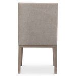 Rear view of Linea chair showcasing smooth upholstered back and solid ash legs in light wood finish