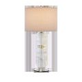 Lamp with faceted optic crystal base seen from front, shade illuminated