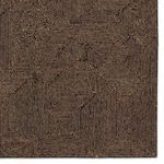 Close-up of the rug's geometric pattern emphasizing the grid-like linear design