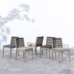 Group of Sherwood Grey chairs with varied cushion colors displayed outdoors on stone patio