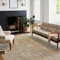 Rosemarie rug shown in a different styled room featuring a fireplace and mid-century modern sofa