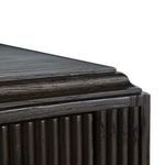 Close-up of the shaped wave-front edge detailing at the top corner of the console.